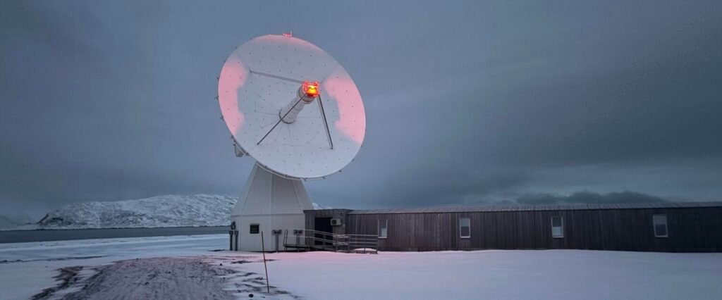 satellite dish ppinting to the sky in a snowy landscape